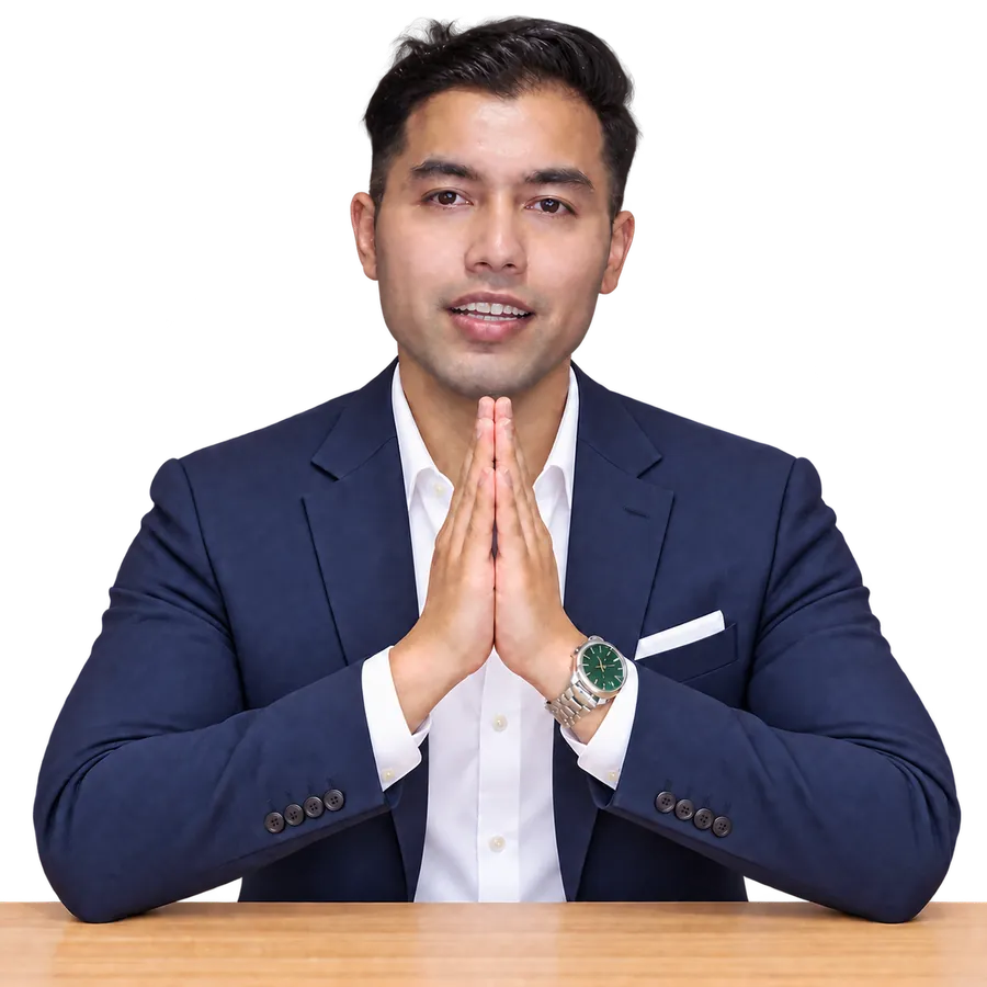 Vinod Thapa welcoming students with namaste, wearing a navy blazer, white formal shirt and premium watch